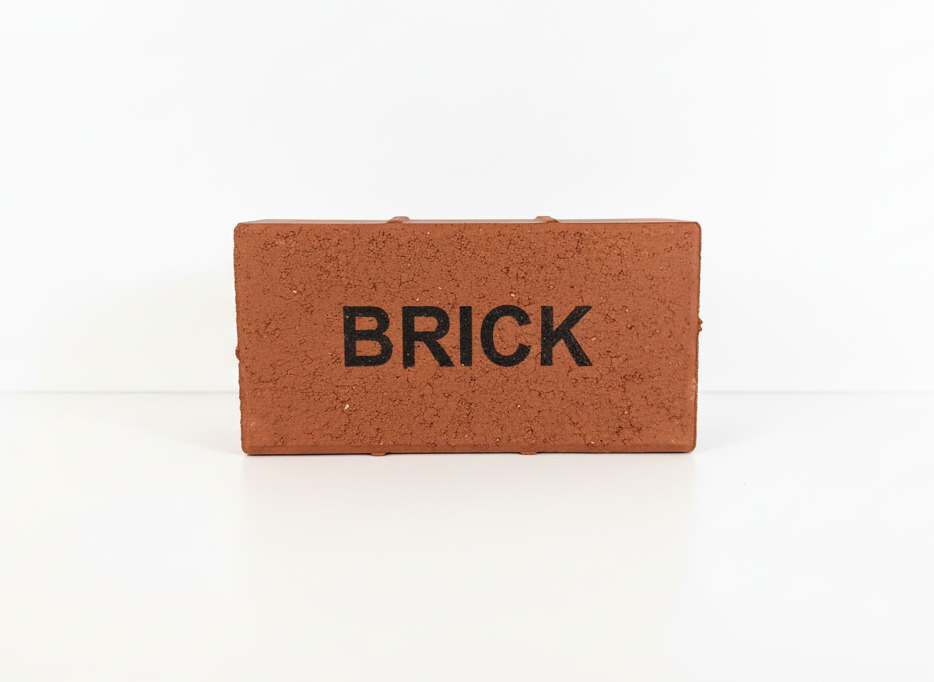 Small brick-shaped object with 'BRICK' text on a white background