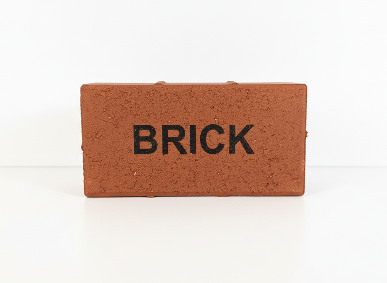 Small brick-shaped object with 'BRICK' text on a white background