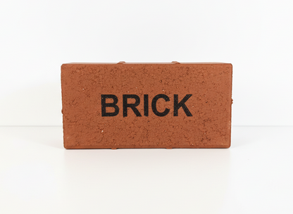 Small brick-shaped object with 'BRICK' text on a white background