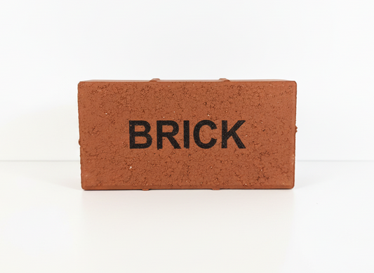Small brick-shaped object with 'BRICK' text on a white background