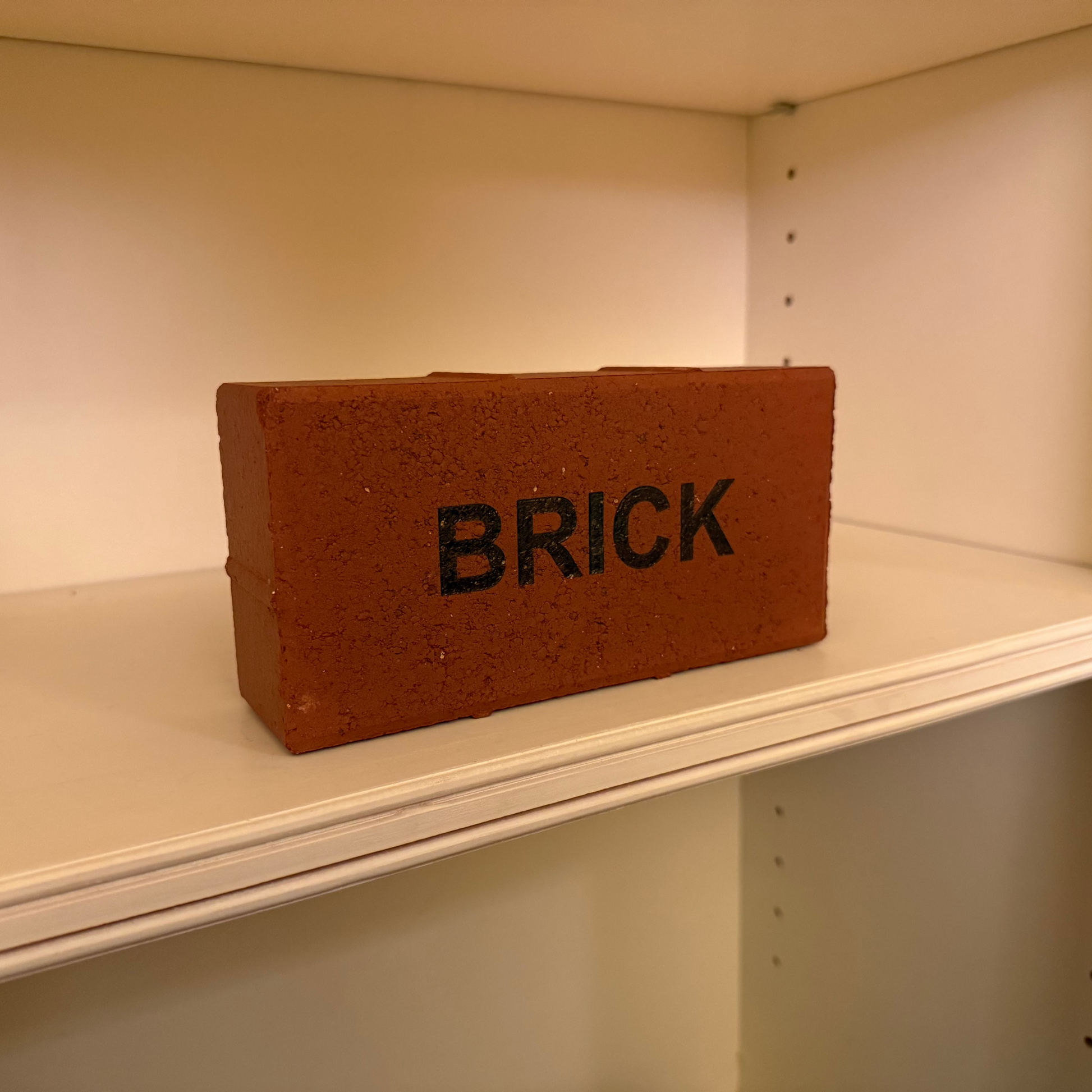 Brick-shaped container labeled 'BRICK' on a shelf